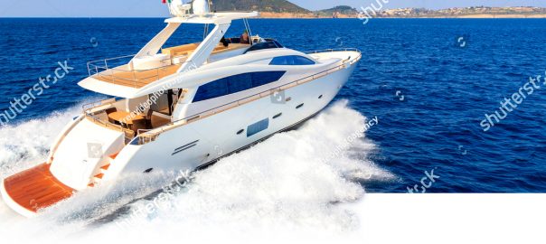 Luxury yacht speeding across blue waters.